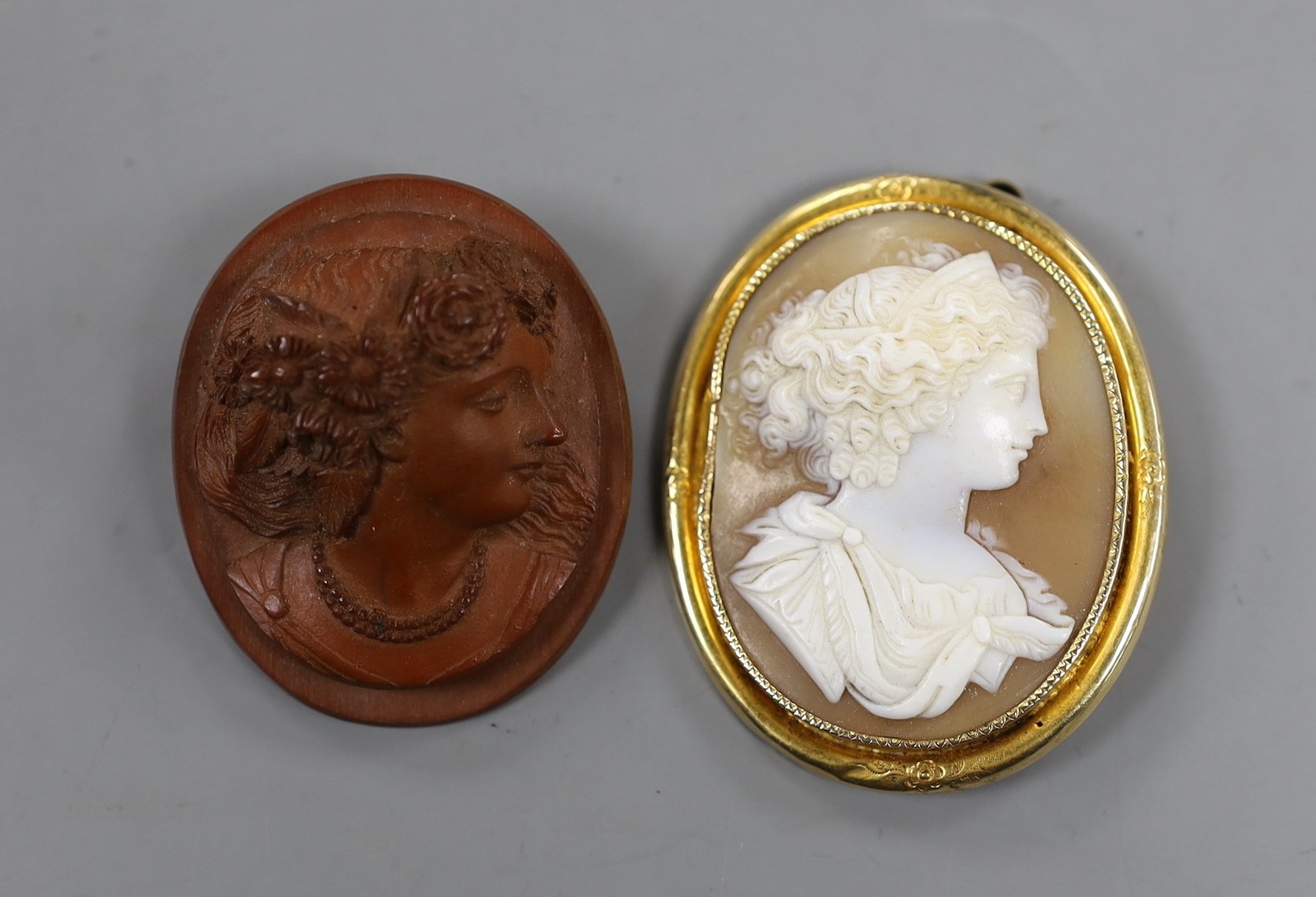 Two cameo brooches including yellow metal mounted cameo shell, carved with the bust of a lady to sinister, 50mm.